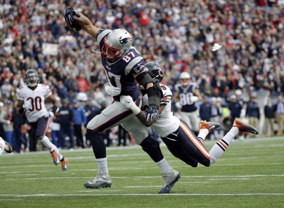 AP Image. New England tight end Rob Gronkowski drags a Chicago defender into the end zone for a touchdown.