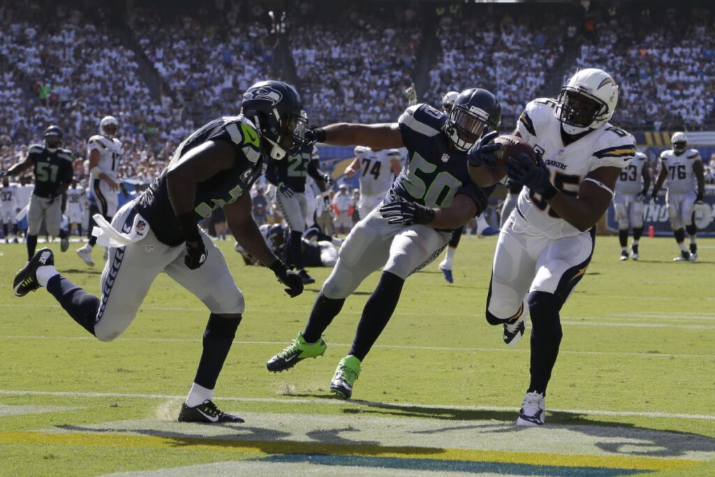 AP Image. Chargers TE Antonio Gates scores a TD against Kam Chancellor and KJ Wright.
