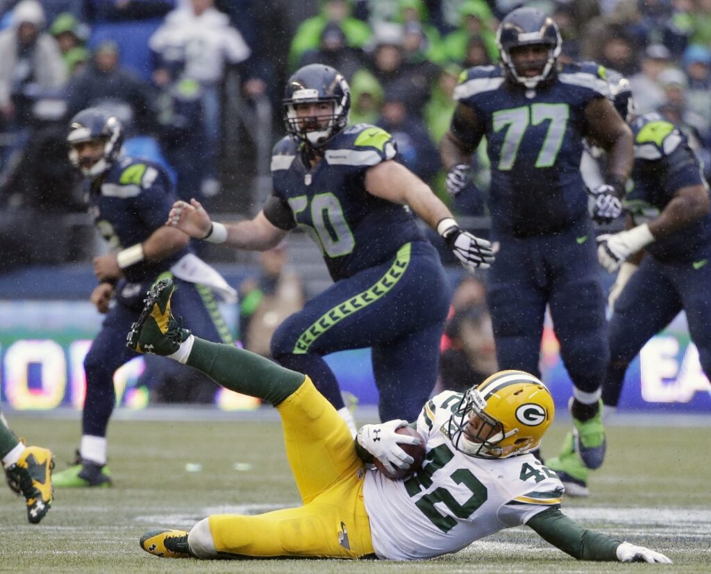 AP Image. Packers safety Morgan Burnett slides to the ground after his 4th Quarter interception.