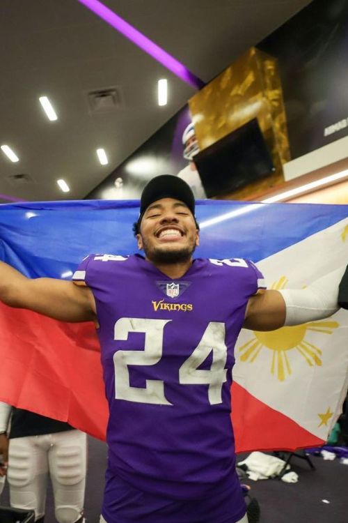 Camryn Bynum Celebrates After A Win In The Dressing Room With The Philippines Flag On His Shoulder In December 2022