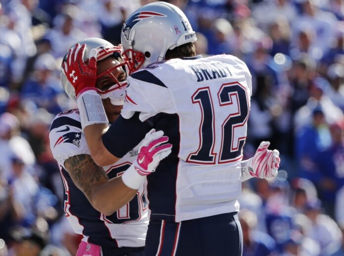 Tom Brady celebrates with WR Brian Tyms after Tyms' 43 yard touchdown grab on Sunday.