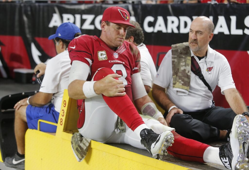 AP Image. Arizona QB Carson Palmer carted off the field after suffering a left knee injury.