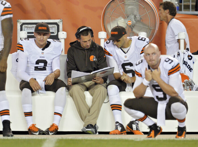 AP Image. Johnny Manziel (L) looks on as former Browns OC Kyle Shanahan works with Brian Hoyer.