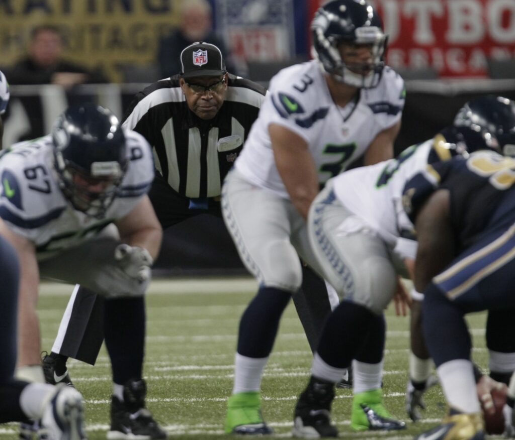 AP Photo. The umpire is positioned here in his normal location in the offensive backfield.